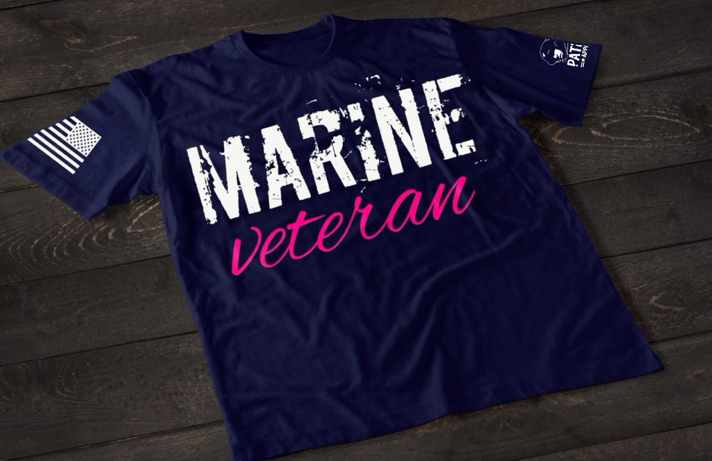 Navy Blue Marine Veteran women’s T-shirt featuring bold white and pink military service text graphic design on the front