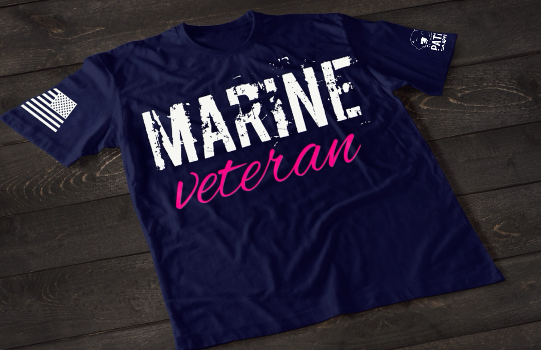 Navy Blue Marine Veteran women’s T-shirt featuring bold white and pink military service text graphic design on the front