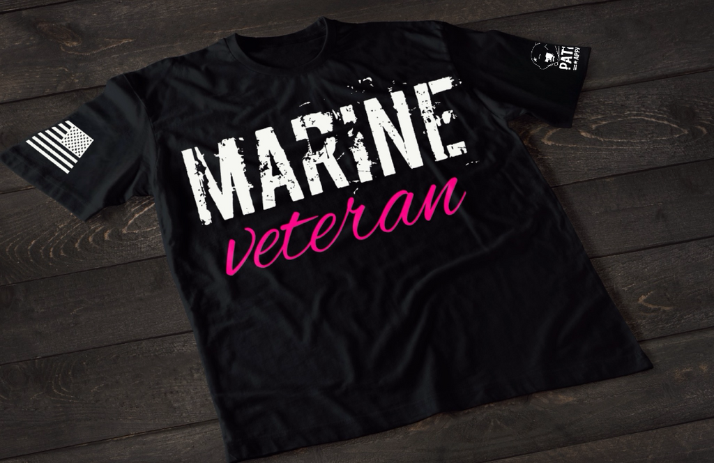 Black Marine Veteran women’s T-shirt featuring bold white and pink military service text graphic design on the front