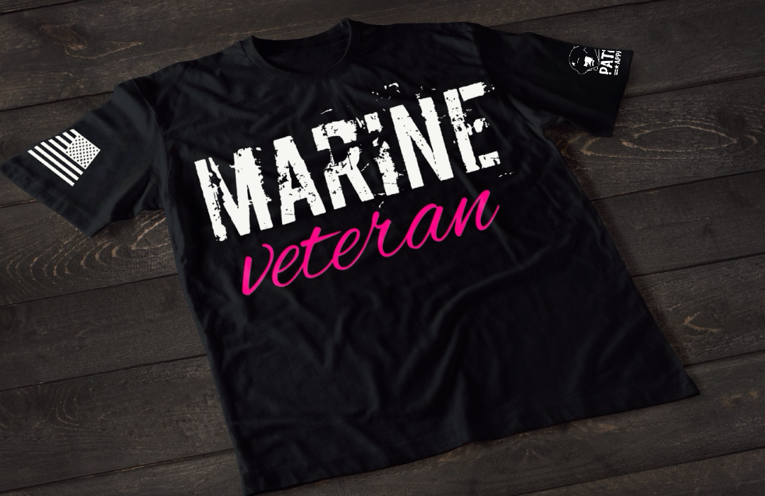 Black Marine Veteran women’s T-shirt featuring bold white and pink military service text graphic design on the front